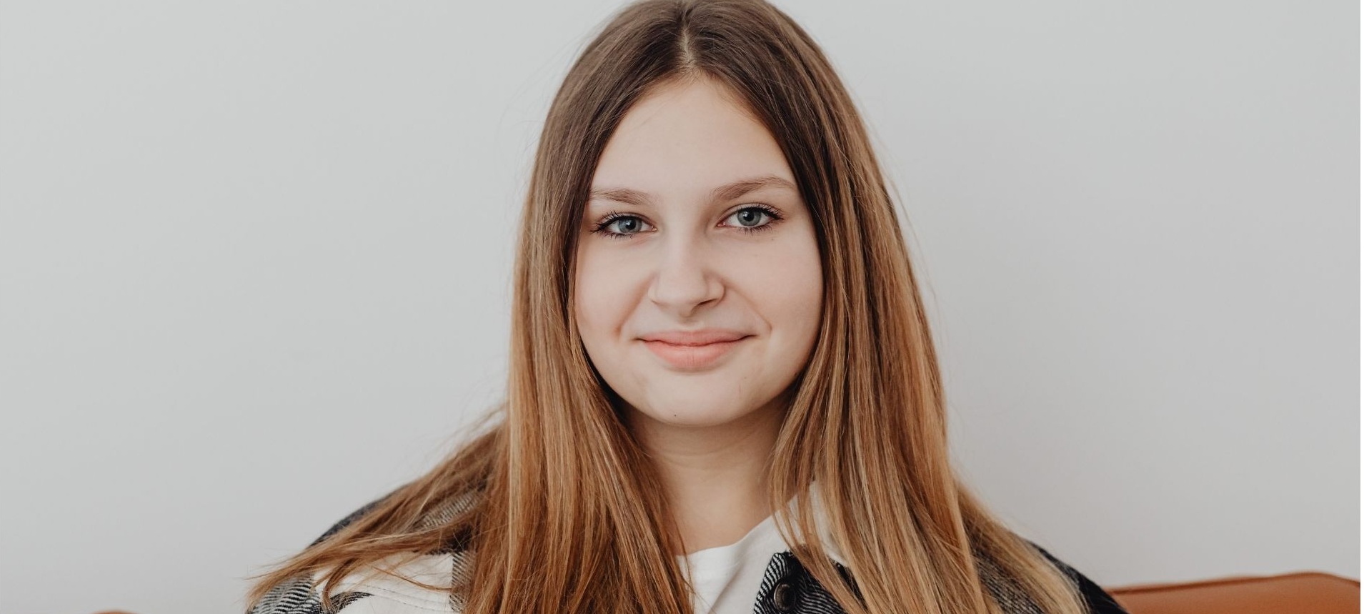 Young woman with long hair smiling gently