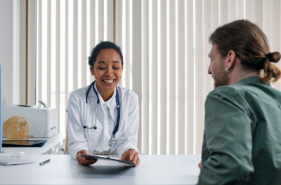 a pitcure of a doctor talking to a patient