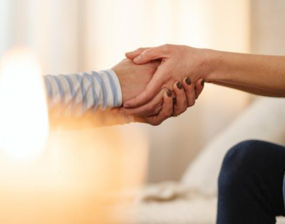 Picture of two adults holding hands.