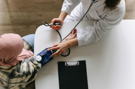 A woman having her blood pressure checked
